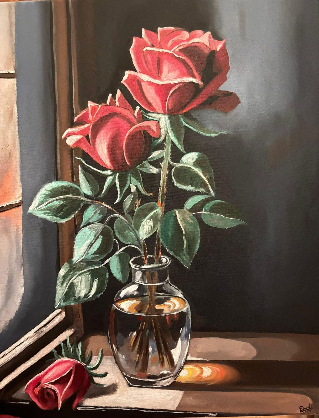 Two Roses at Dusk by Deepti Dasika: Classical still life: two red roses in a glass vase on a windowsill, a fallen bud and book, warm light against a dark wall.